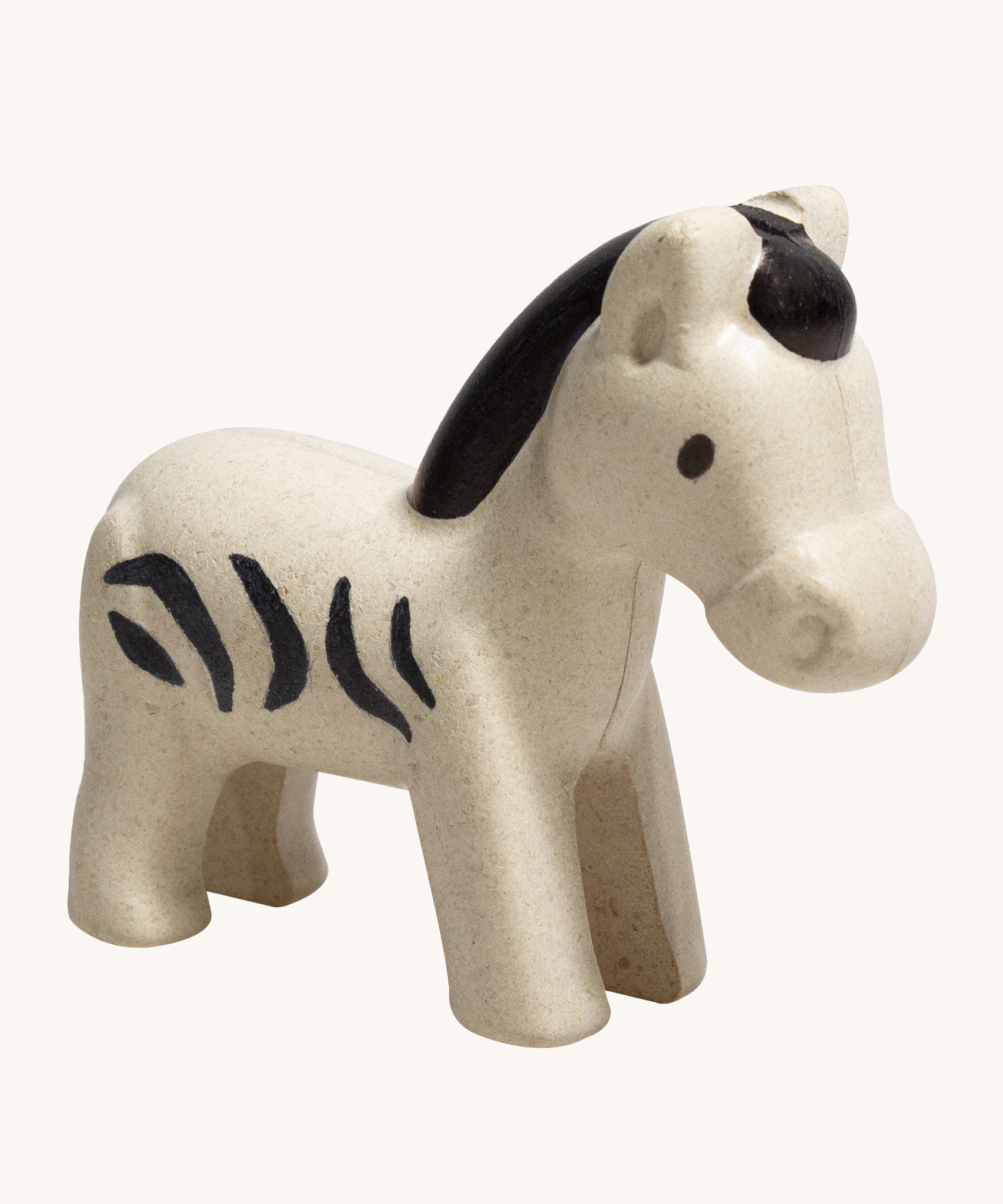 The PlanToys Zebra is an adorable wild animal toy for little ones. Made from PlanWood, this zebra is white with black stripes, a black mane and eyes , and is on a cream background