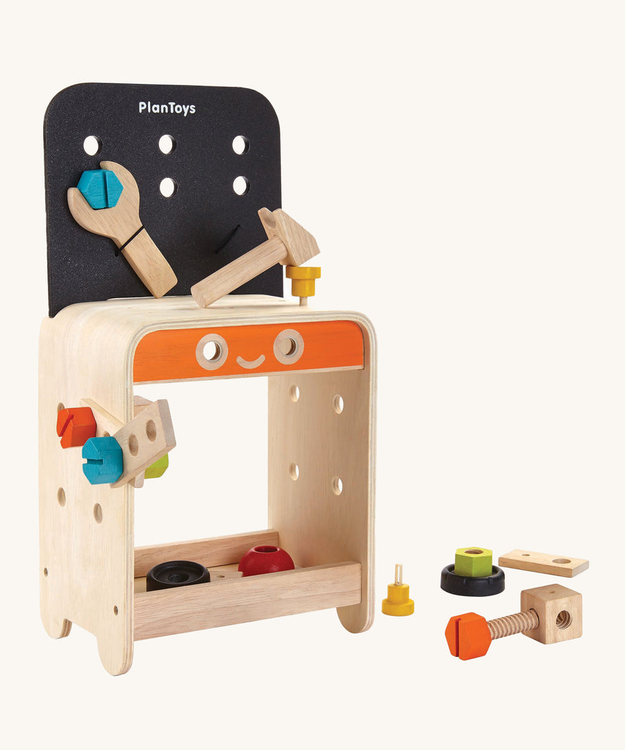 PlanToys Workbench is a great STEM activity toy for little ones. The work bench comes with various wooden screws, nuts, bolts, blocks, a spanner, and a hammer which can all be screwed or hammered onto the work bench, and can be stored in a space underneath the workbench. The image is on a cream background