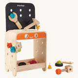 PlanToys Workbench is a great STEM activity toy for little ones. The work bench comes with various wooden screws, nuts, bolts, blocks, a spanner, and a hammer which can all be screwed or hammered onto the work bench, and can be stored in a space underneath the workbench. The image is on a cream background