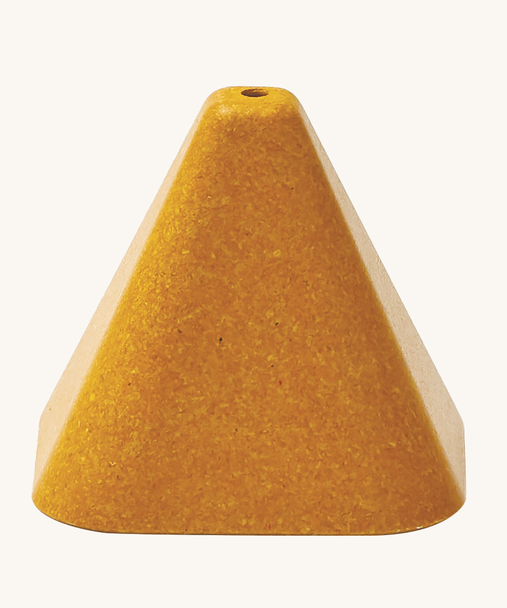 The yellow triangle block from the PlanToys Creative Sand Play, with a ole in the top to allow for water to be poured through