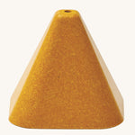 The yellow triangle block from the PlanToys Creative Sand Play, with a ole in the top to allow for water to be poured through