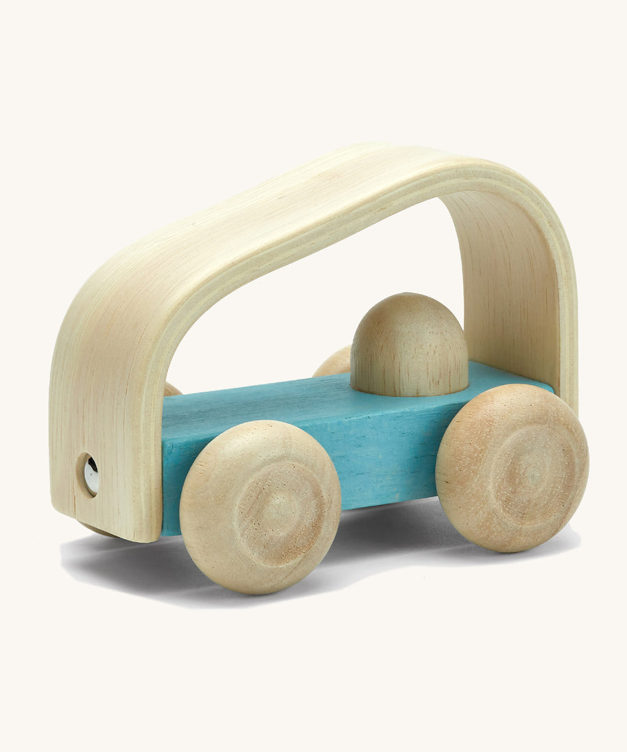 Plan toys eco-friendly wooden vroom car vehicle toy on a cream background