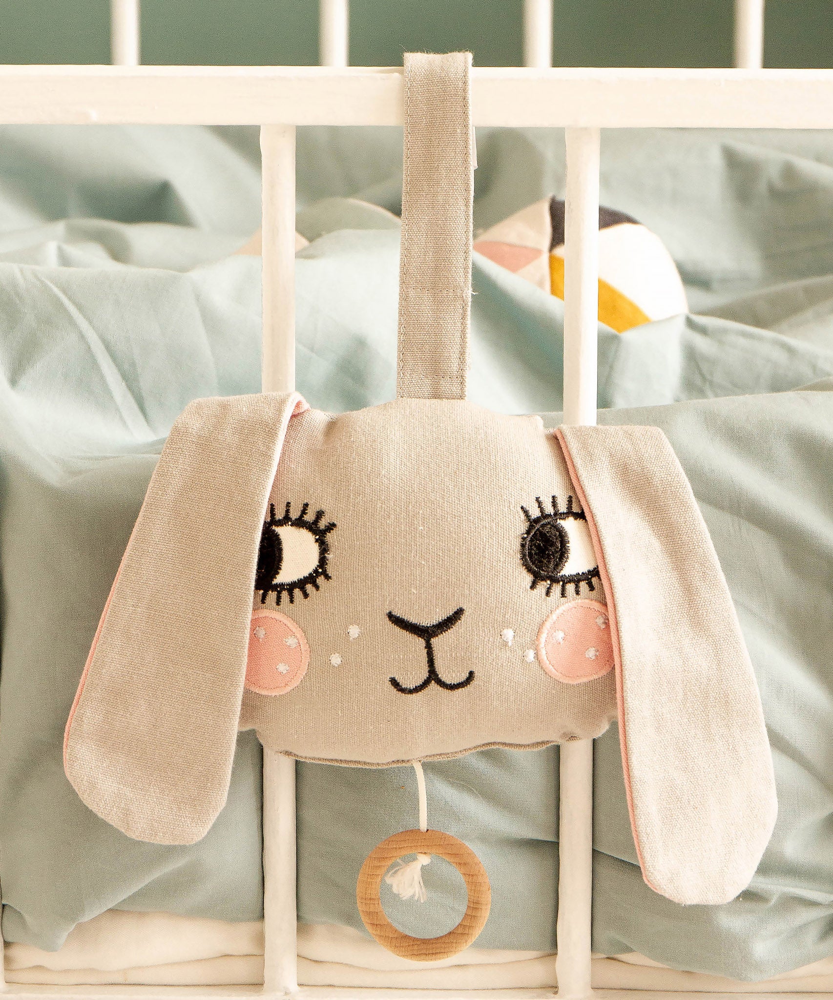 Roommate Musical Baby Mobile - Bunny on the side of a white baby cot