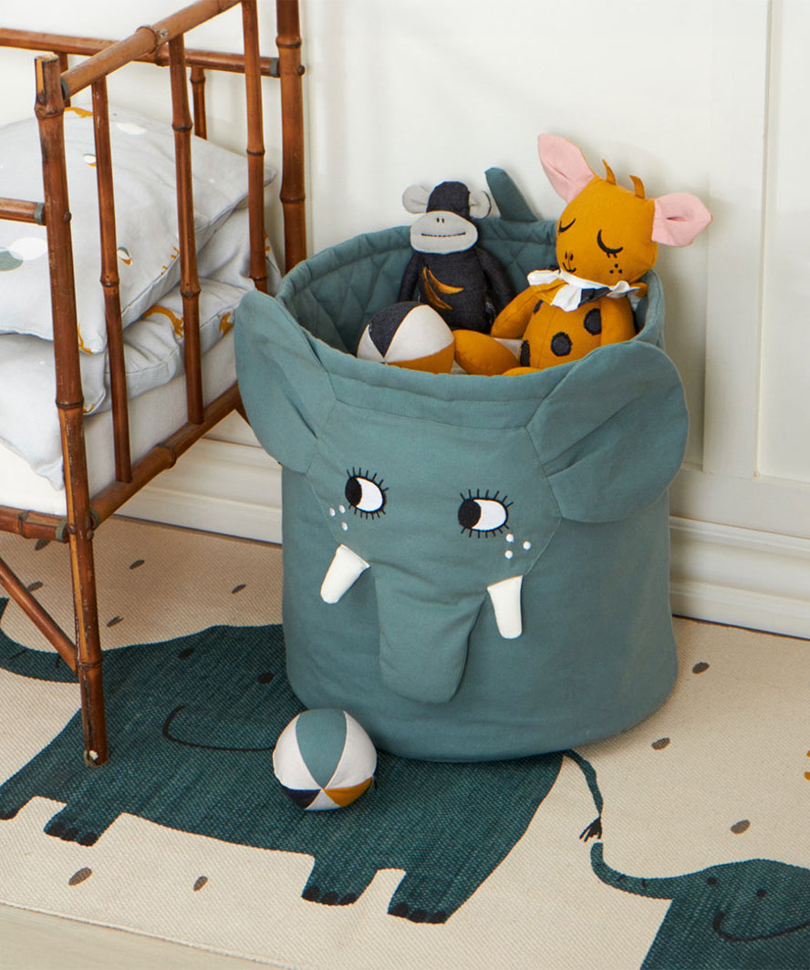 A Roommate elephant laundry basket with Roommate toys and balls inside