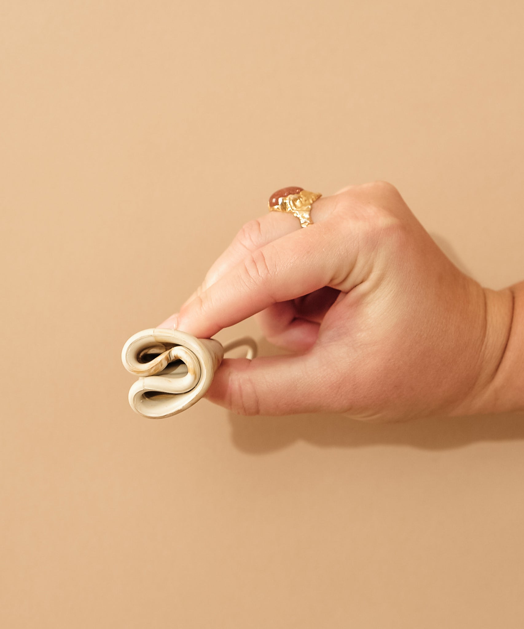 Person demonstrating how to fold a HEVEA LOOP menstrual cup.