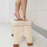 Toddler with bare legs on tiptoes on a Hevea Rubberwood Step Stool