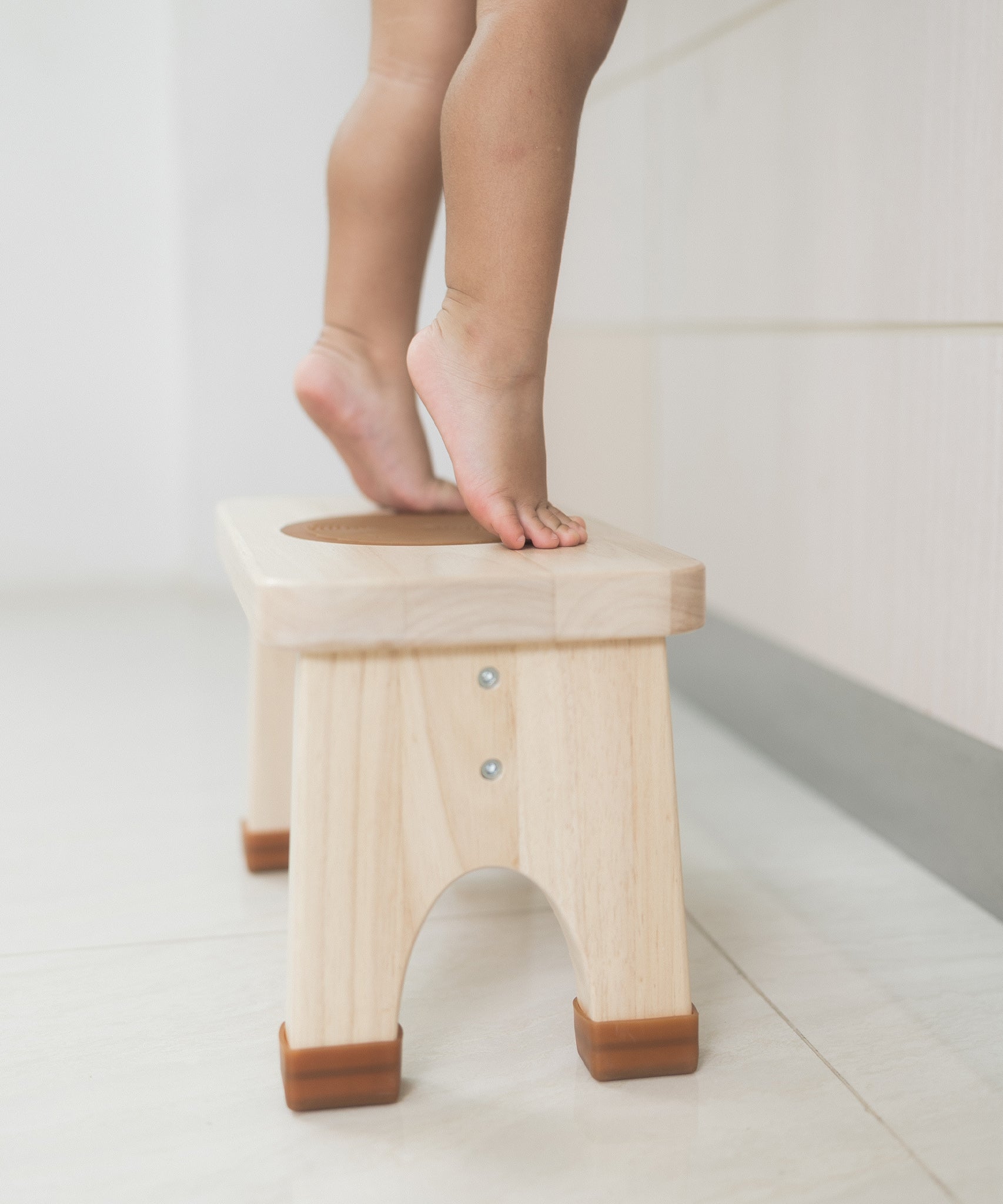 Toddler with bare legs on tiptoes on a Hevea Rubberwood Step Stool