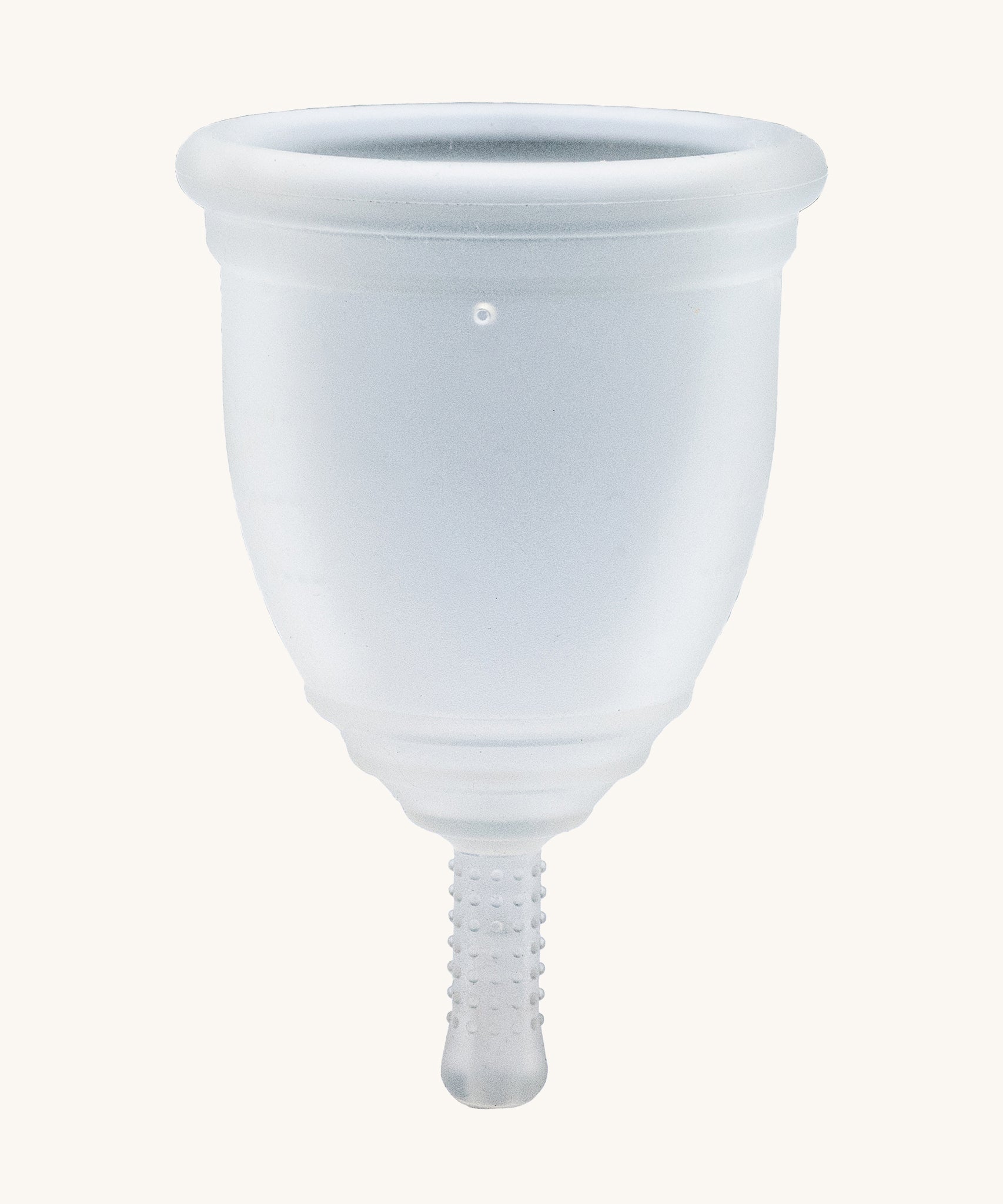 Ruby Cup Menstrual Cup in clear silicone, on a cream background