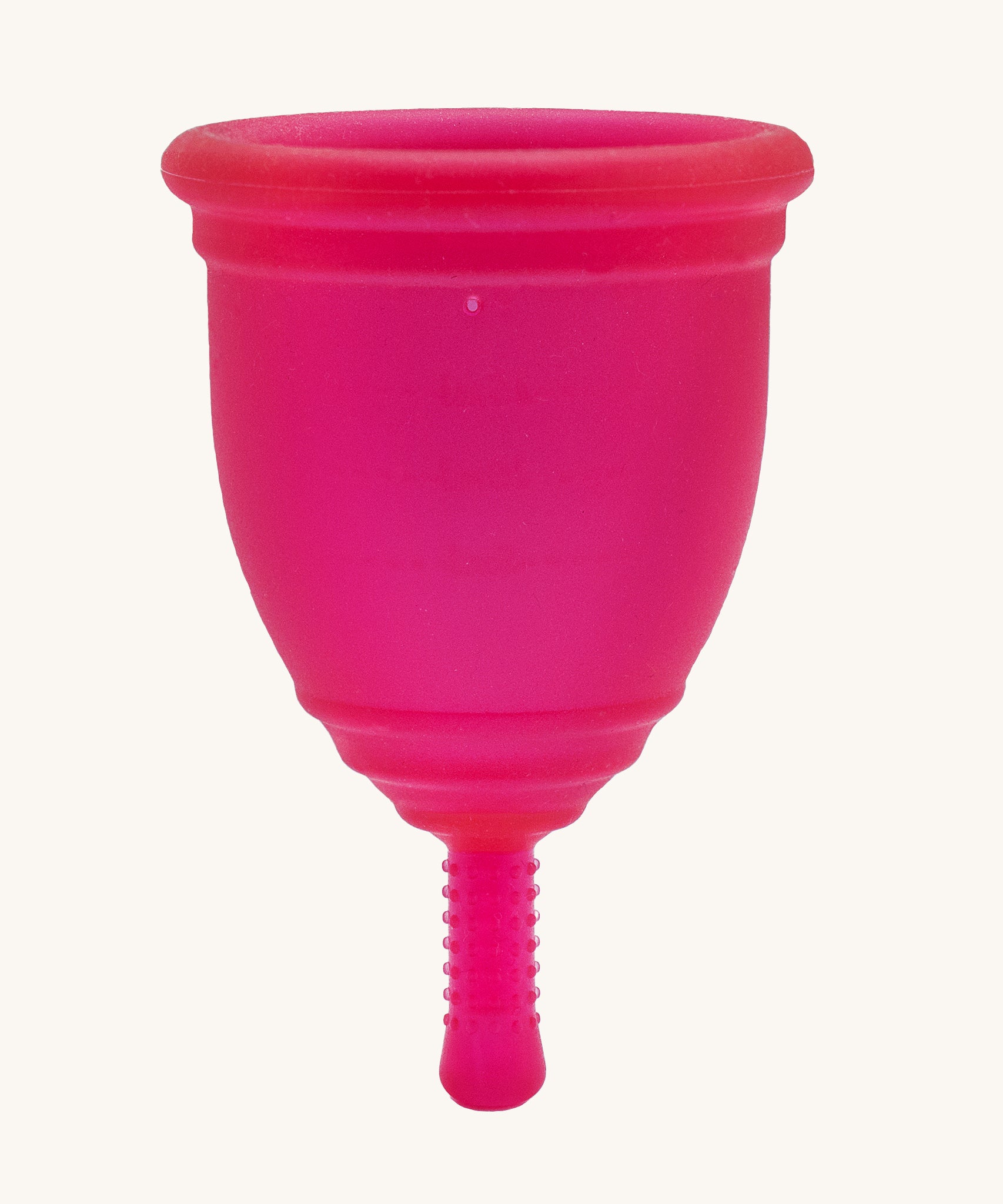 Ruby Cup Menstrual Cup in red silicone, on a cream background