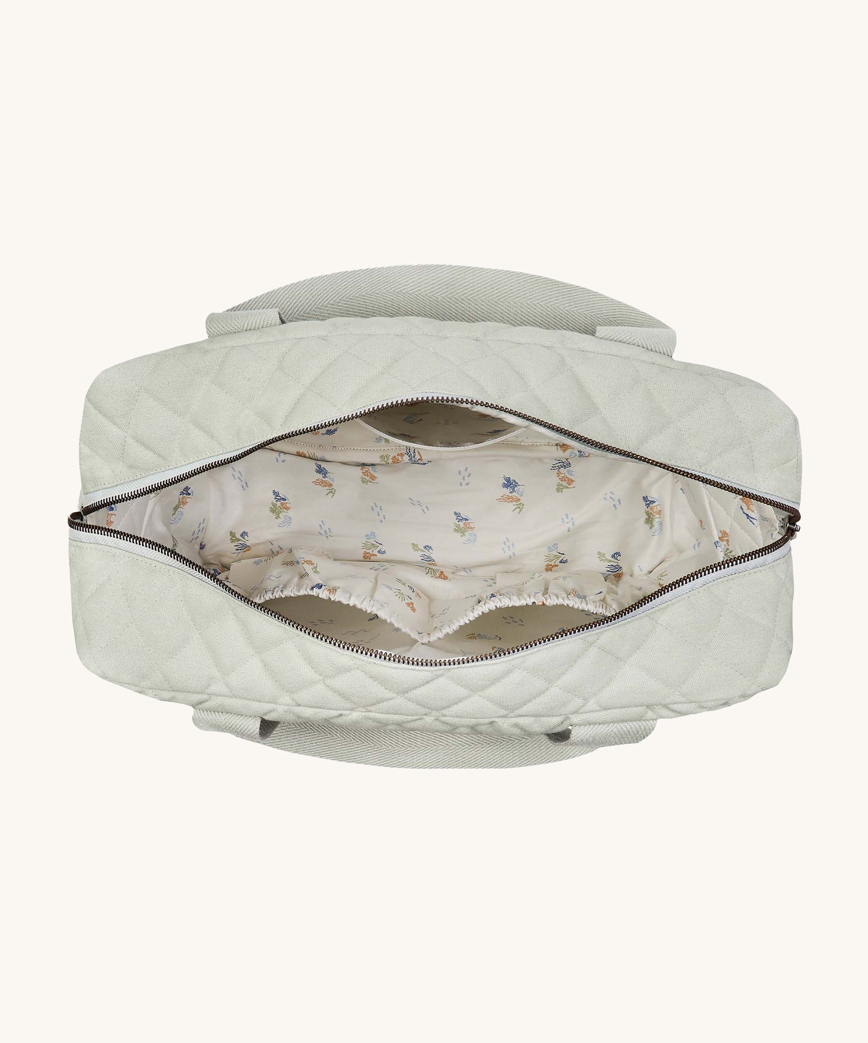 The Avery Row Nappy Changing Bag - Sage, open showing the lining and compartments inside