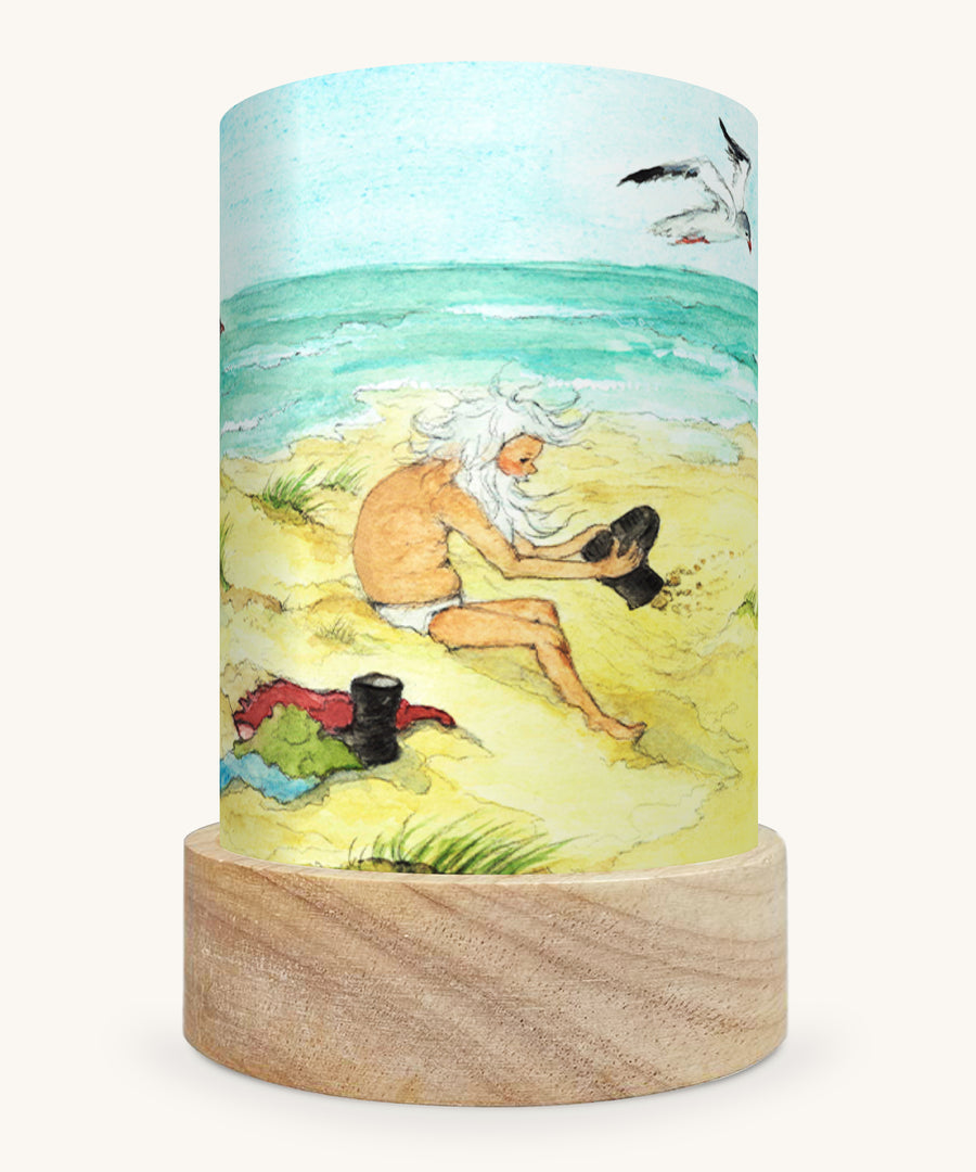 The Sea Gnome illustration by Eentje Van Margo sat in a Toverlux Magic Lantern base, on a cream background