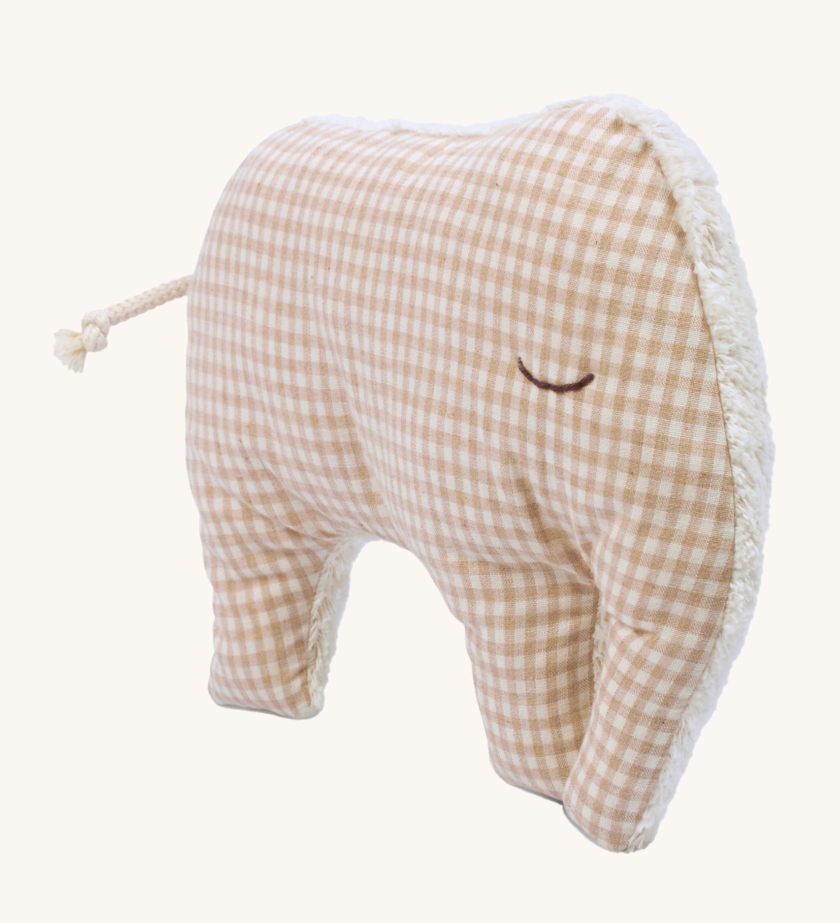 The peach cotton check fabric side of the Senger Cuddly Animal Cushion - Elephant, with the other side as a cream fluffy fabric. The image is on a cream background