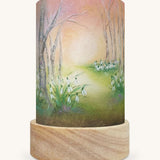 The Snow Drops illustration by Baukje Exler sat in a Toverlux Magic Lantern base.