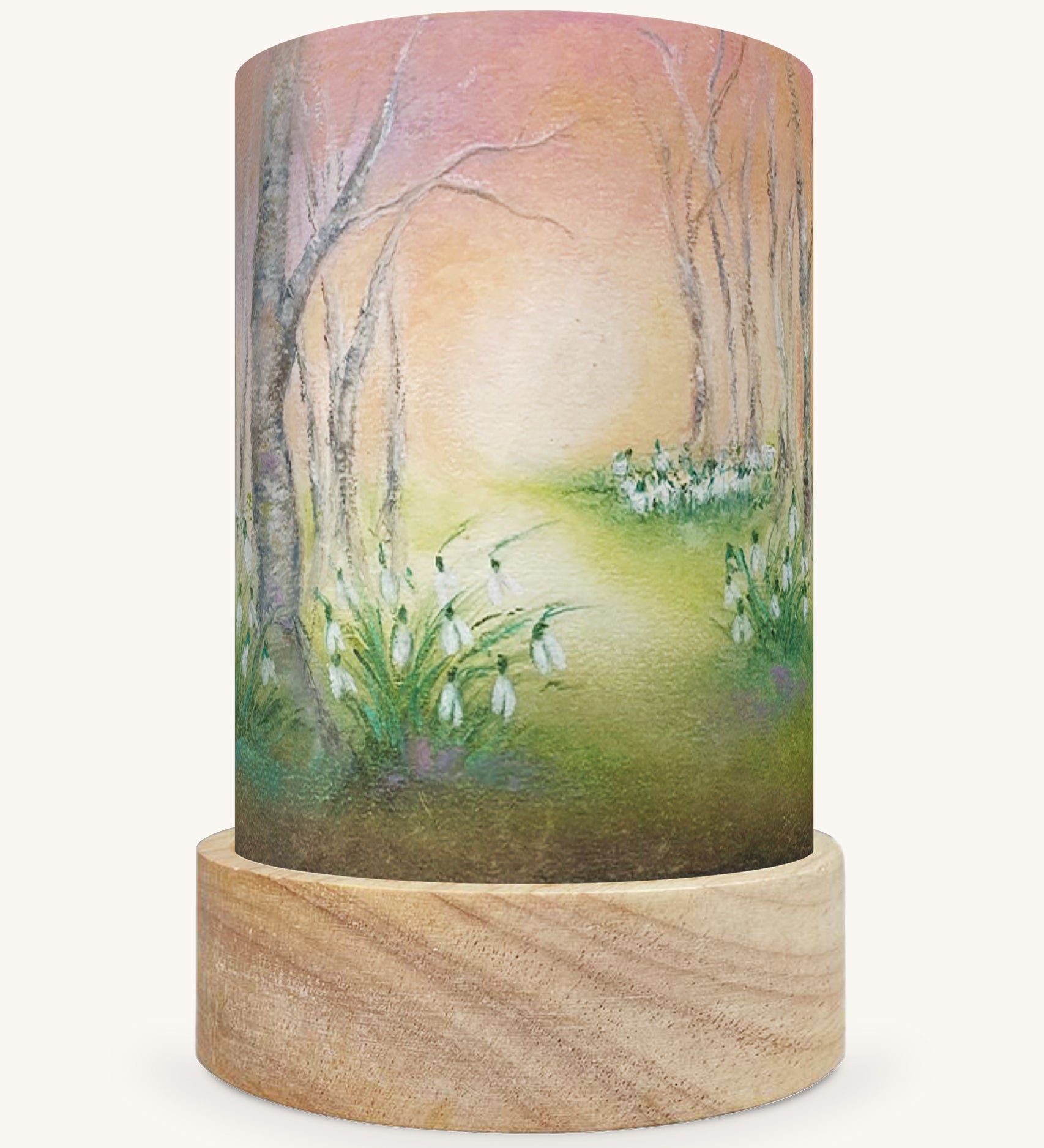 The Snow Drops illustration by Baukje Exler sat in a Toverlux Magic Lantern base, on a cream background