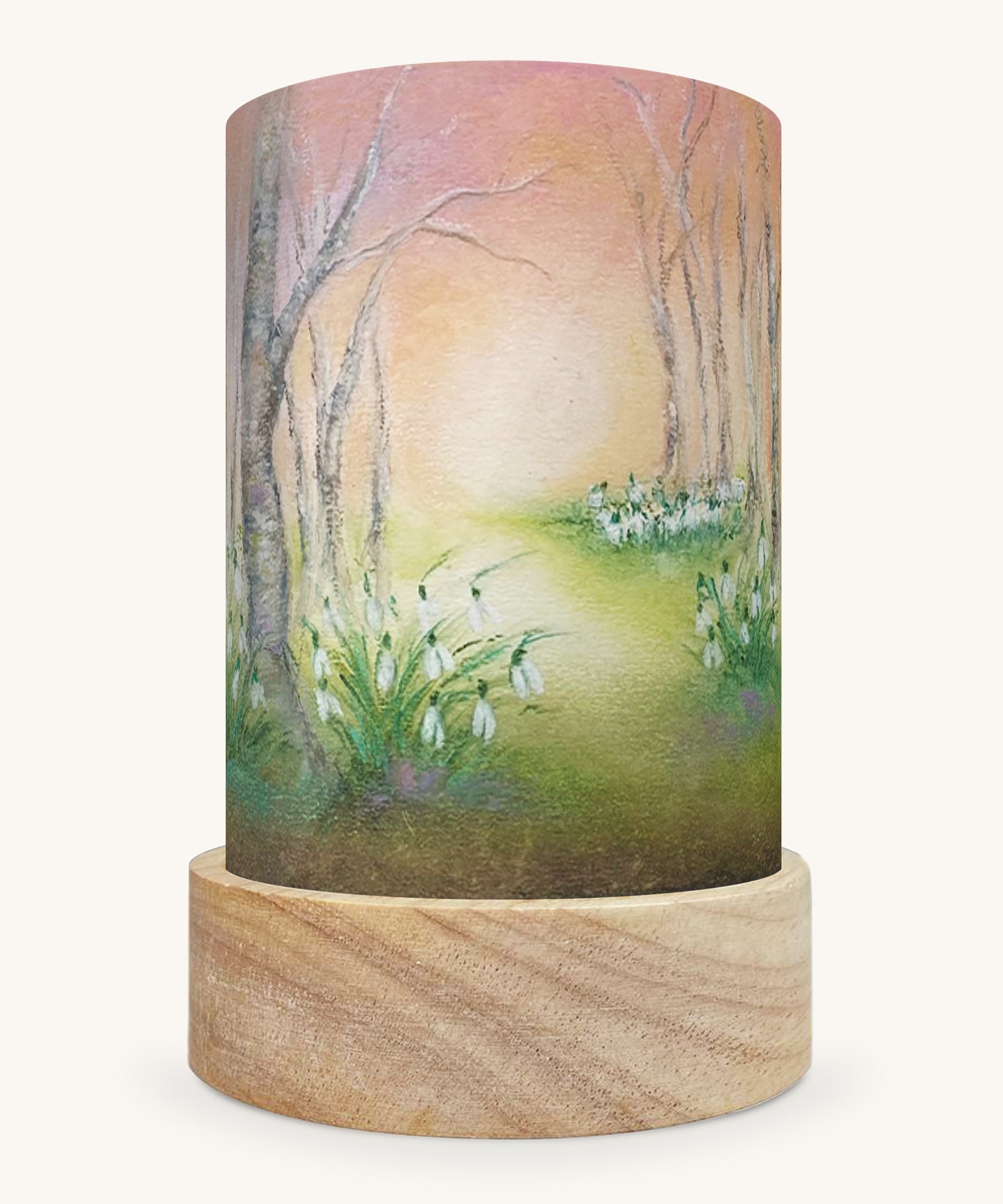 The Snow Drops illustration by Baukje Exler sat in a Toverlux Magic Lantern base.