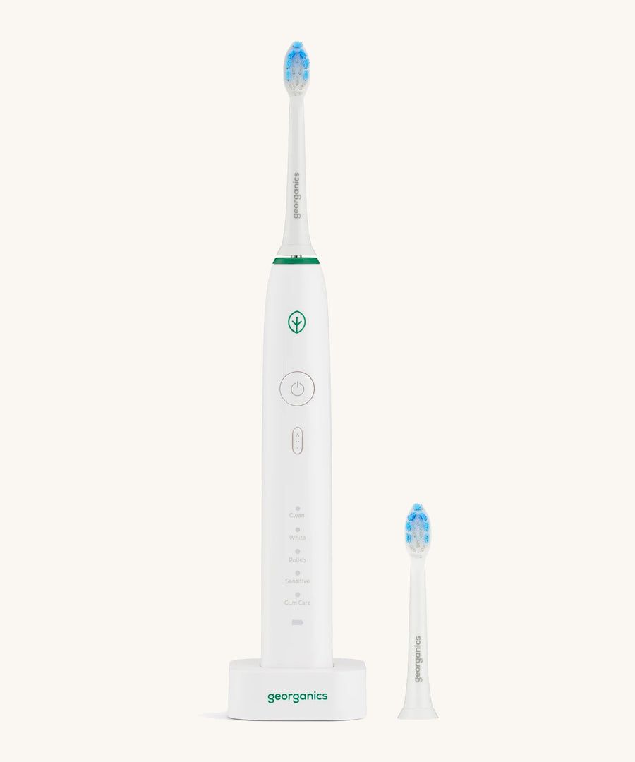 A Georganics sonic toothbrush set with the 50000spm replacement head on a cream background