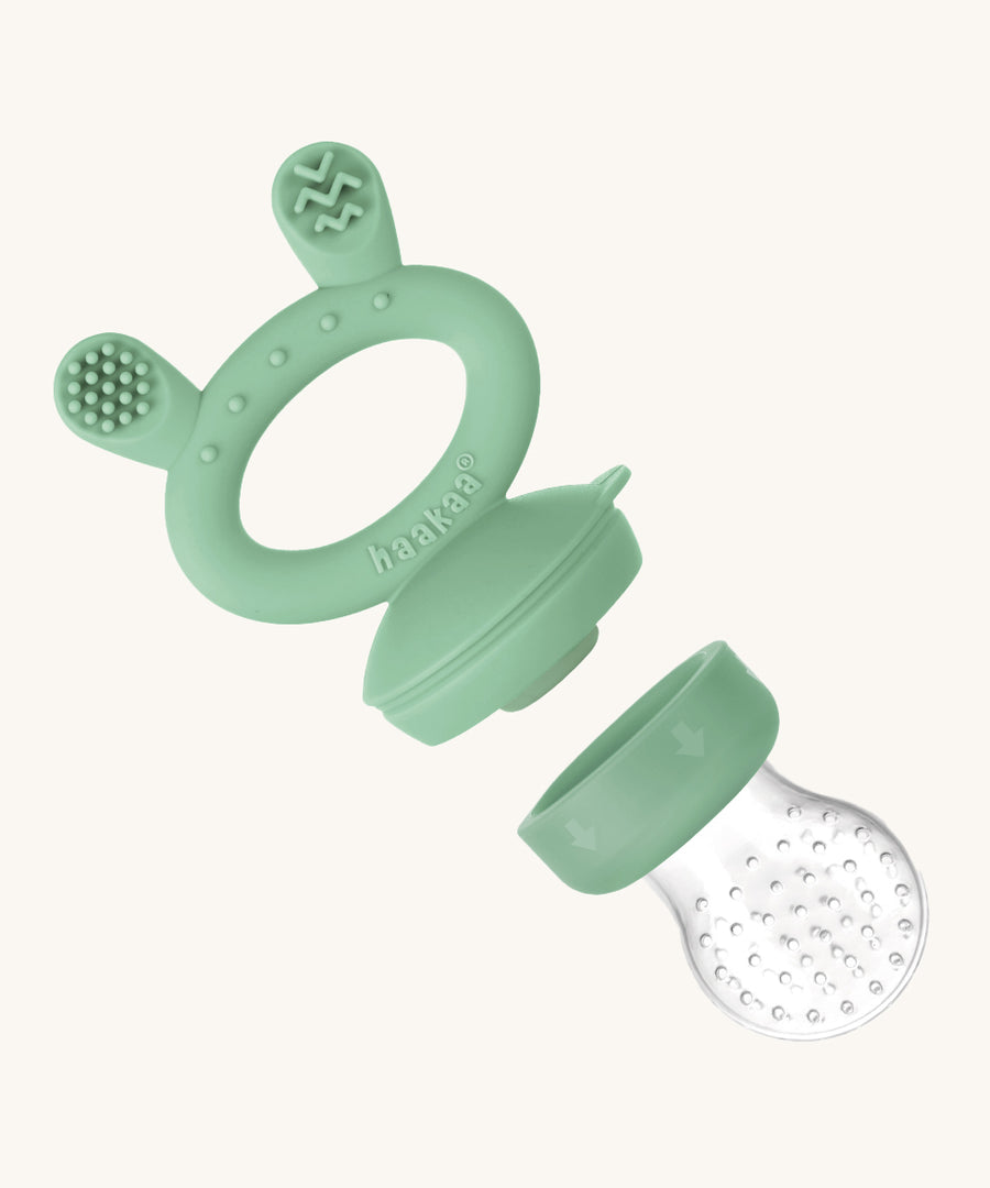 The Haakaa Silicone Freeze-N-Feed Mini Set feeder on a cream background. The image shows the feeder part removed from he handle to add food inside