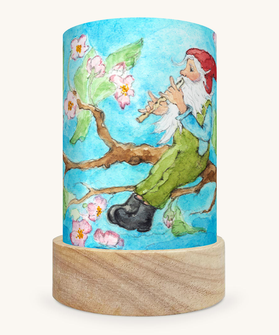 The Spring Gnome illustration by Eentje Van Margo sat in a Toverlux Magic Lantern base, on a cream background