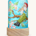 The Spring Gnome illustration by Eentje Van Margo sat in a Toverlux Magic Lantern base, on a cream background