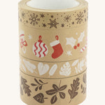 A stack of Babipur Kraft Eco Tape, with snowflakes, Christmas decorations, White leaves and Brown leaves, on a cream background