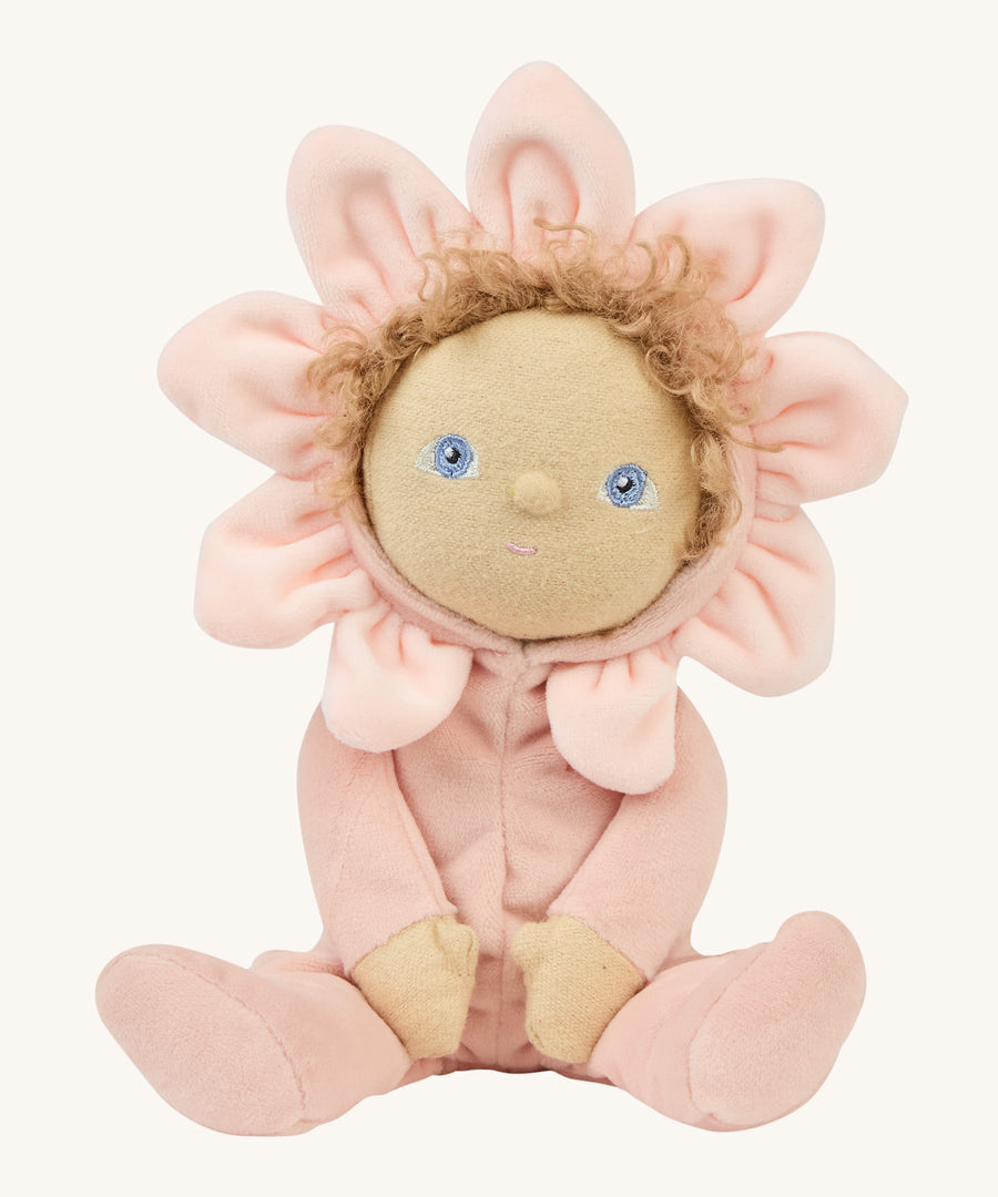 A light pink dinky dinkum doll sitting on a cream background.