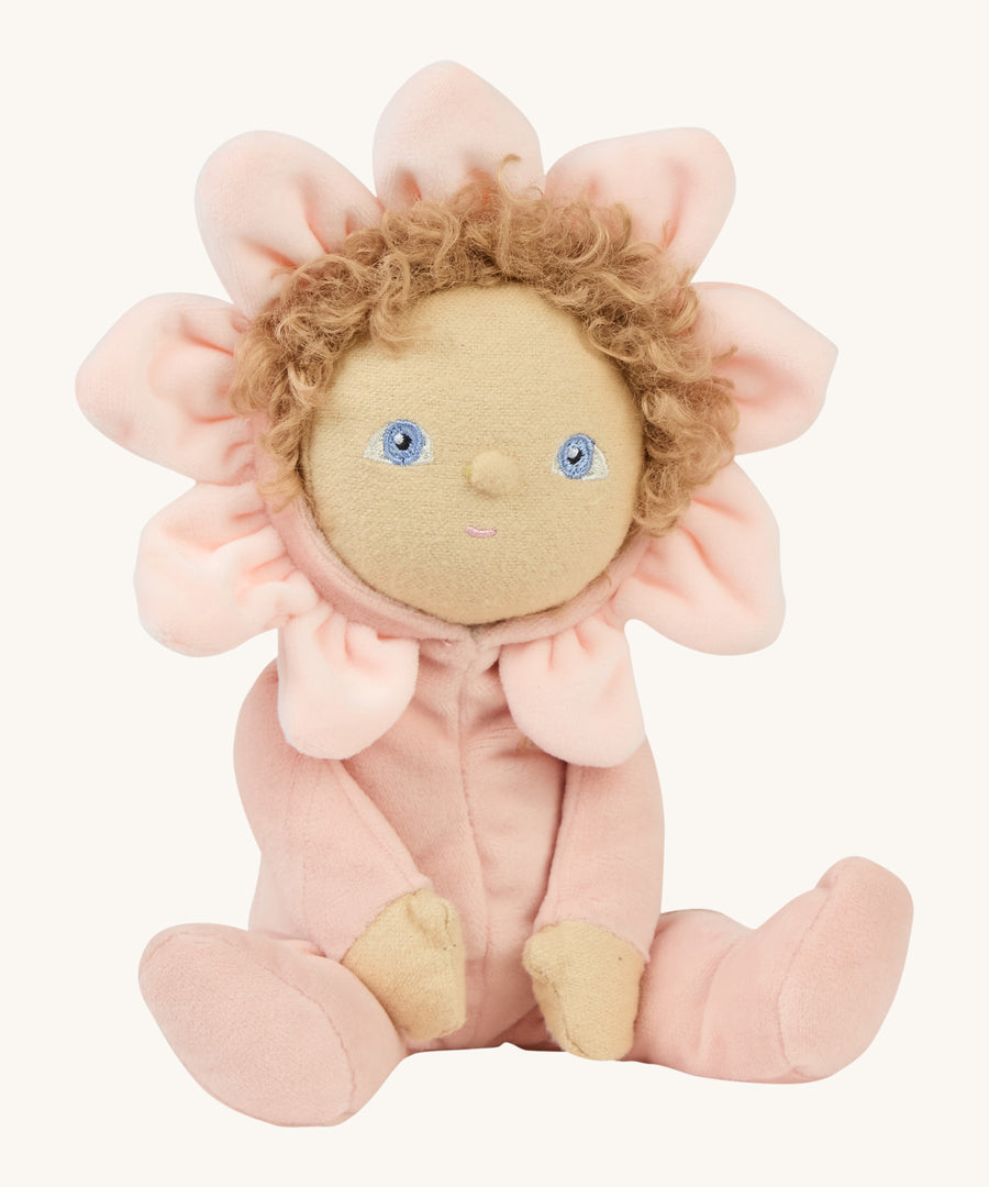 A side photo of the light pink dinky dinkum doll sitting on a cream background.