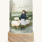 The Herdress illustration by Robin Pieterse sat in a Toverlux Magic Lantern base, on a cream background