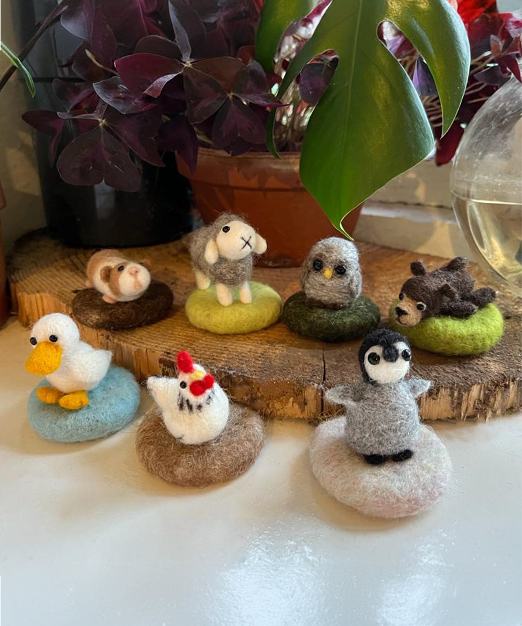 A collection of The Makerss - Amiguwoolli figures which includes a duck, chicken, penguin, bear, owl, sheep and guinea pig