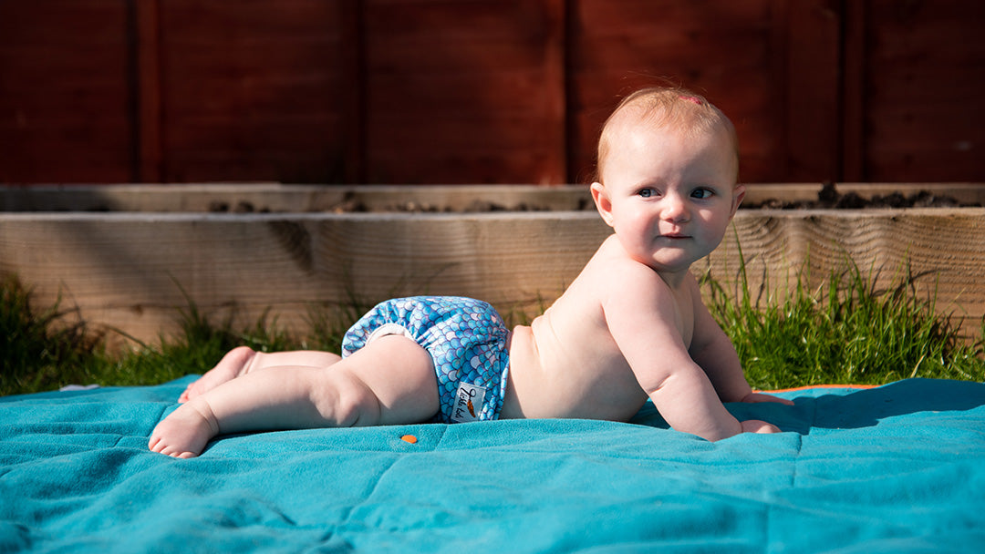 Baby wearing a Tickle Tots reusable nappy