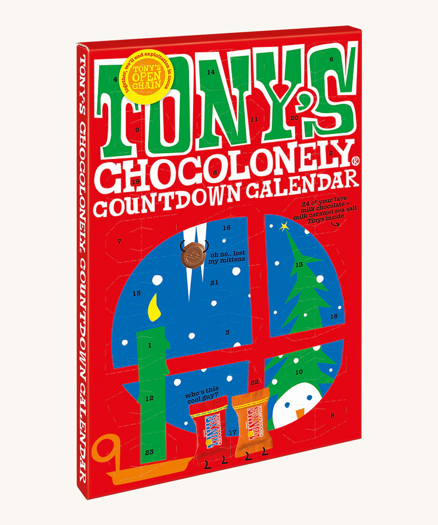 An angeld view of the The front of the Tony's Chocolonely Chocolate Advent Calendar - Fairtrade and Organic - Small 216g showing the calendar windows ready to open. The image is on a cream background