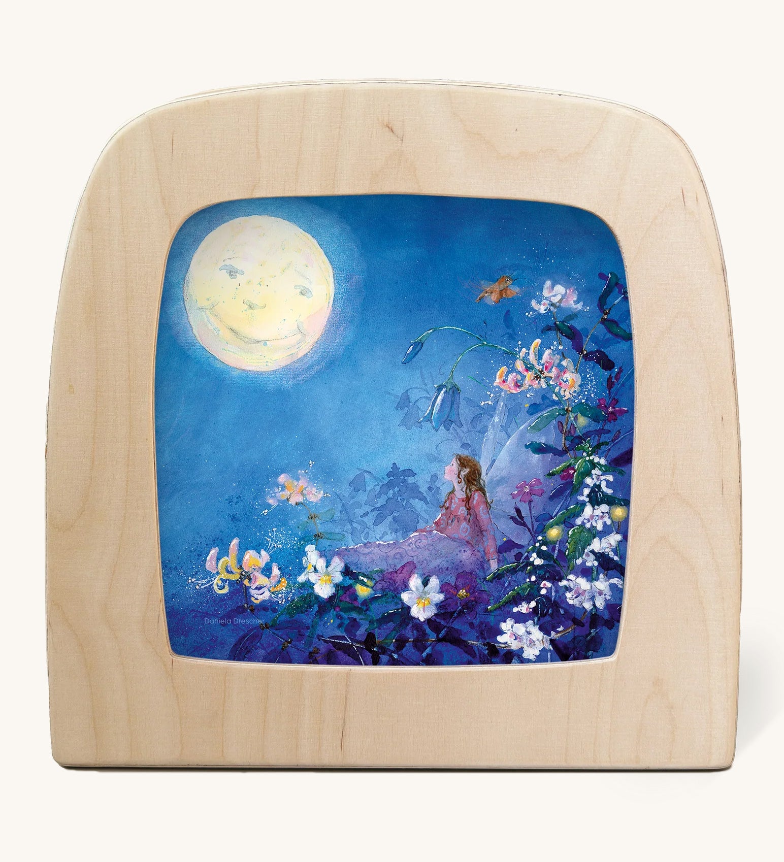 The Little Fairy Can't Sleep - Moon illustration by Daniela Drescher sat in a Toverlux Magic Lamp, on a cream background. The mage shows a fairy laying in bed underneath colourful flowers with a full moon in the sky