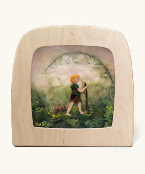 Toverlux Magic Lamp Silhouette - Artwork By Het Wol Feetje, Little Explorer. A felt illustration of a person walking in a grassy area with a rabbit following behind. The image is on a cream background