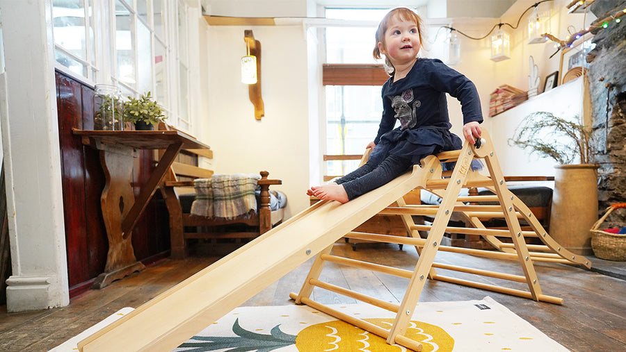 Child sliding down the Miri Slide on the Triclimb