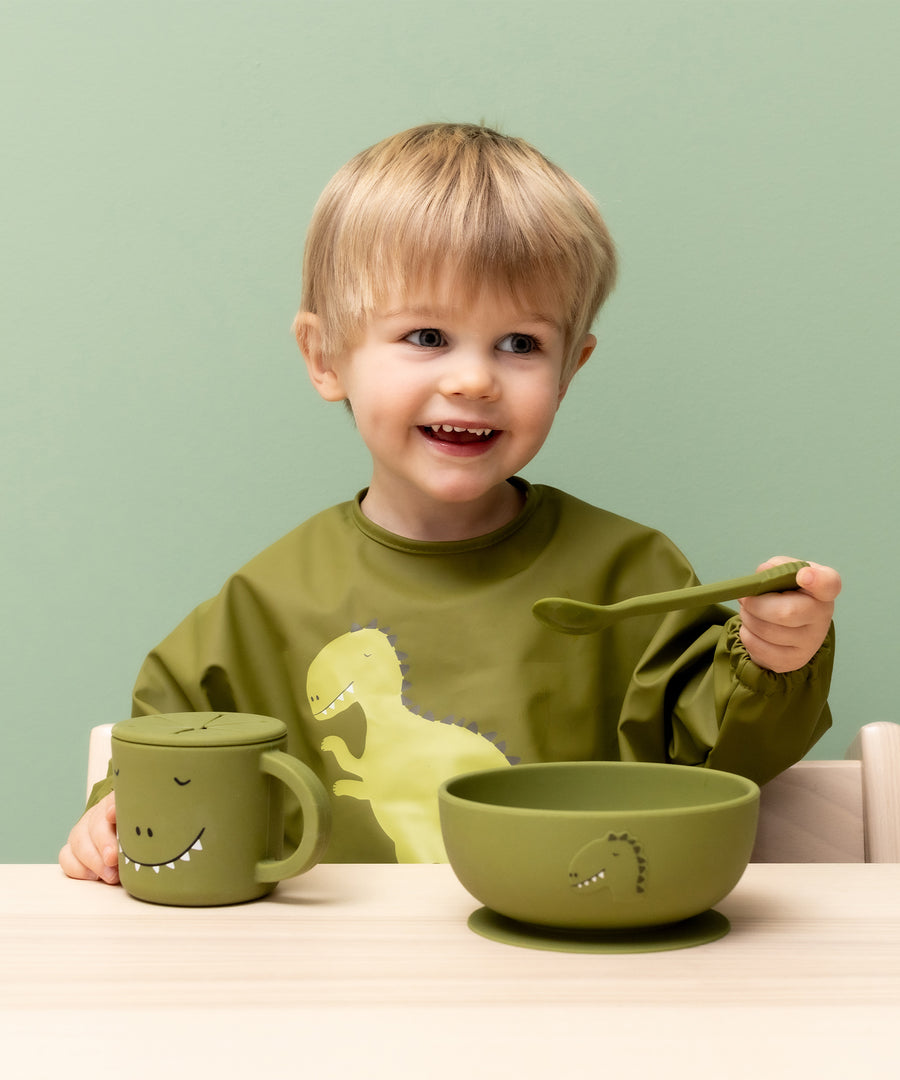 Child eating from the Trixie Animal Friends Silicone Suction Bowl, green, Mr Dino.