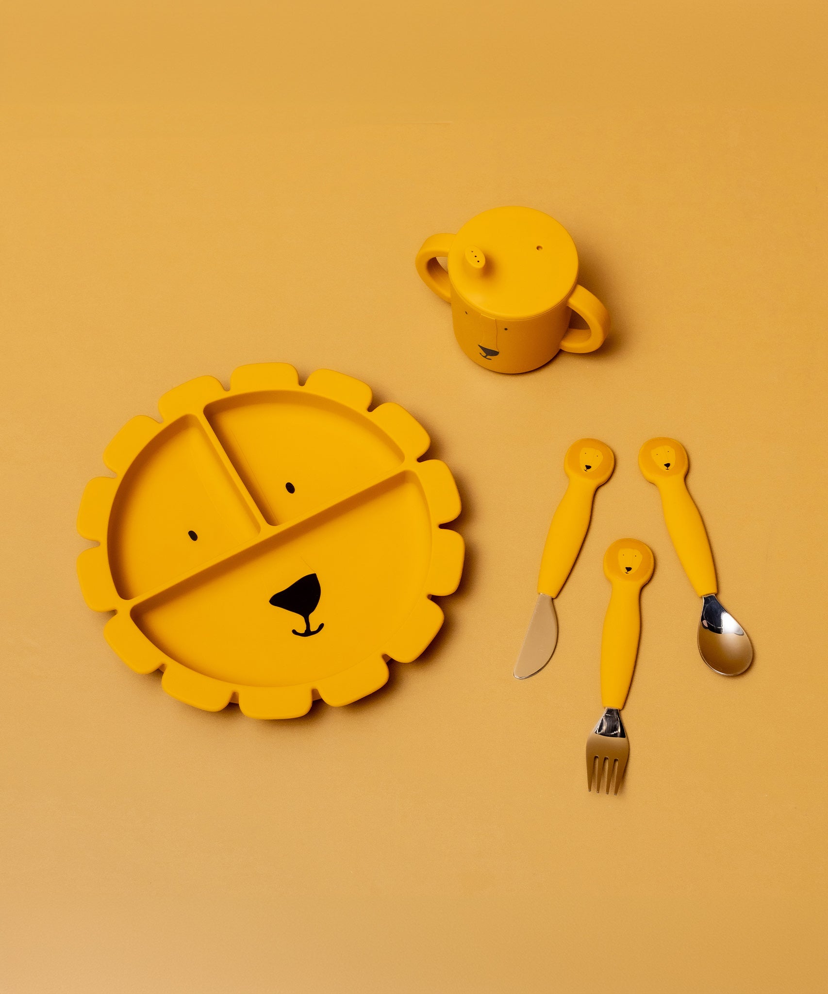 Child eating from the Trixie Animal Friends Silicone Divider Plate, yellow, Mr Lion. With matching sippy cup and cutlery set. 