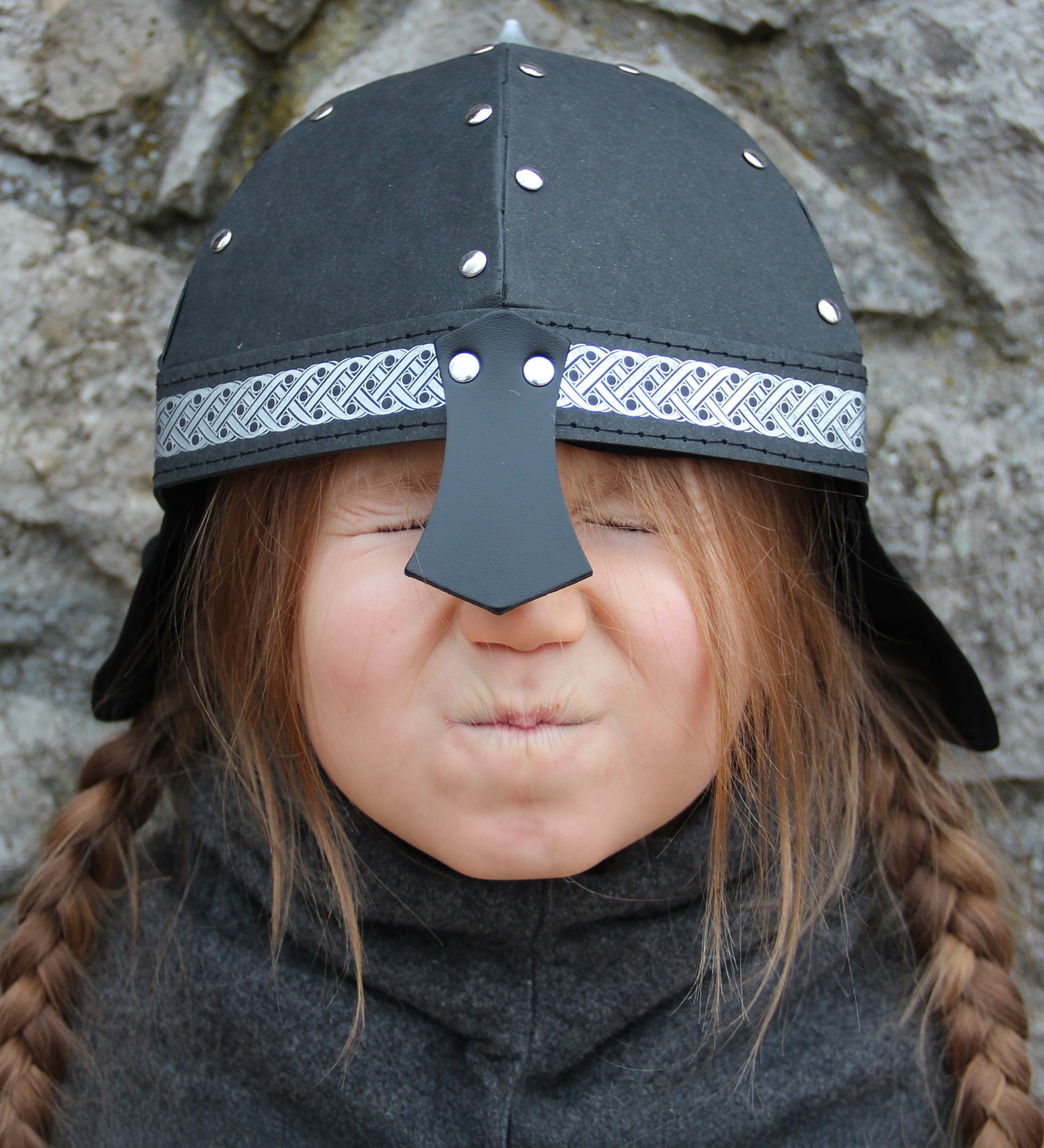 Child wearing Knight Helmet outdoors in play