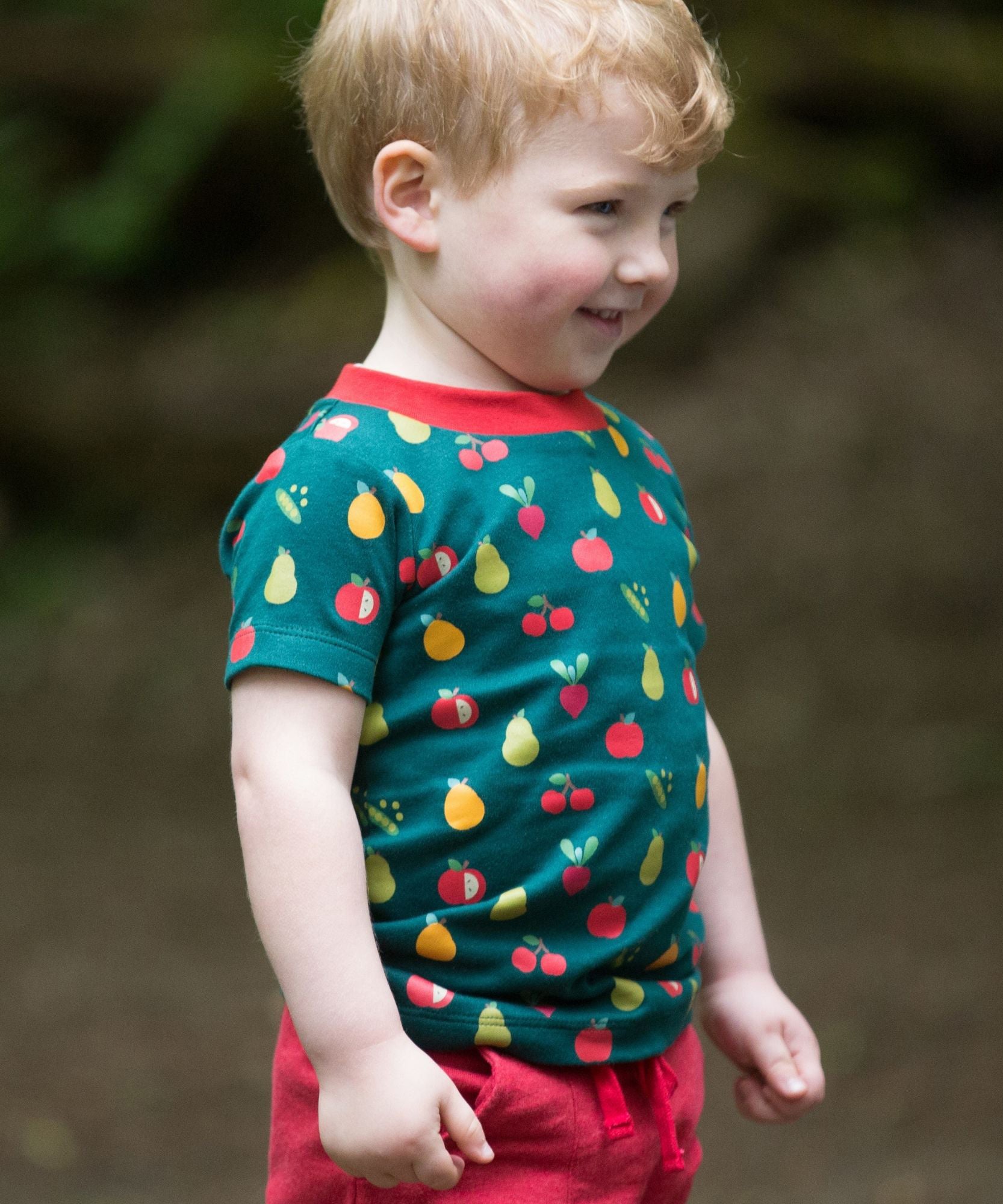 A child happily outside, wearing the LGR Vegetable Patch Short Sleeve T-Shirt