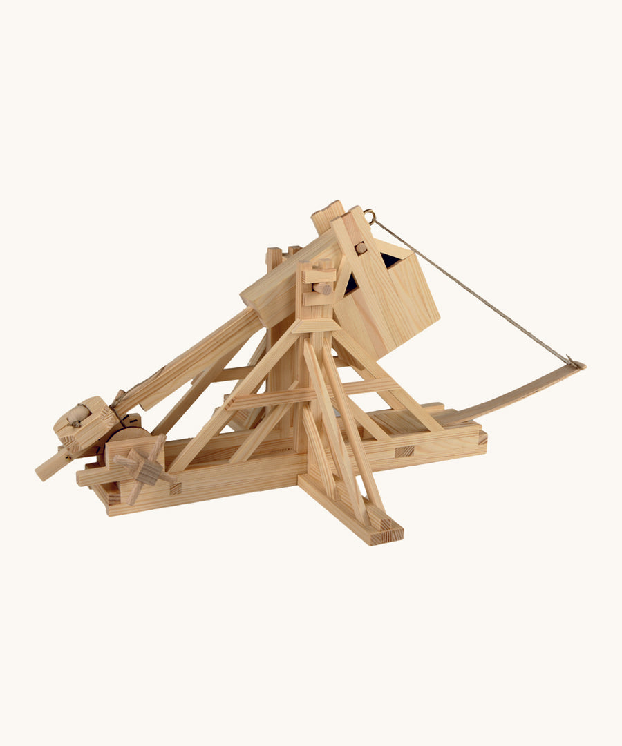 The Walachia Wooden Trebuchet building set, with the movable arm bent back, ready to fire the small wooden ball inside.