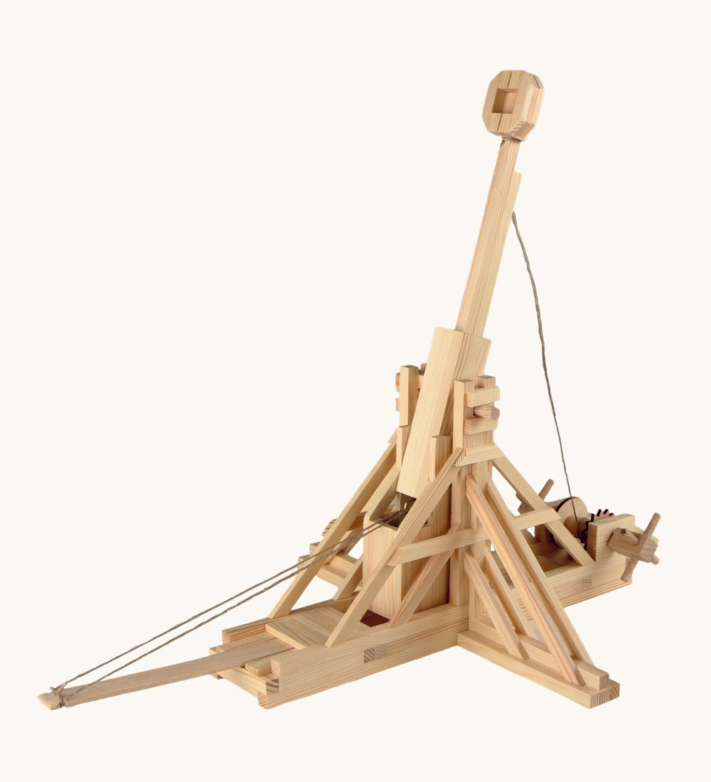 The Walachia wooden Trebuchet building toy, made from wooden parts, on a cream background. The image shows the wooden pieces constructed to make a working DIY Trebuchet