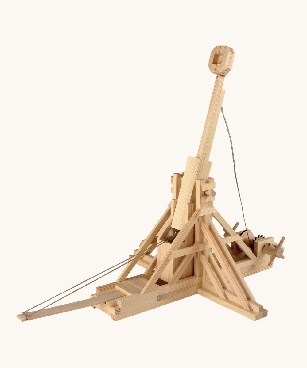 The Walachia wooden Trebuchet building toy, made from wooden parts, on a cream background. The image shows the wooden pieces constructed to make a working DIY Trebuchet