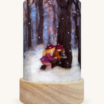 The Winter Discoveries illustration by Het Wol Feetje sat in a Toverlux Magic Lantern base, on a cream background