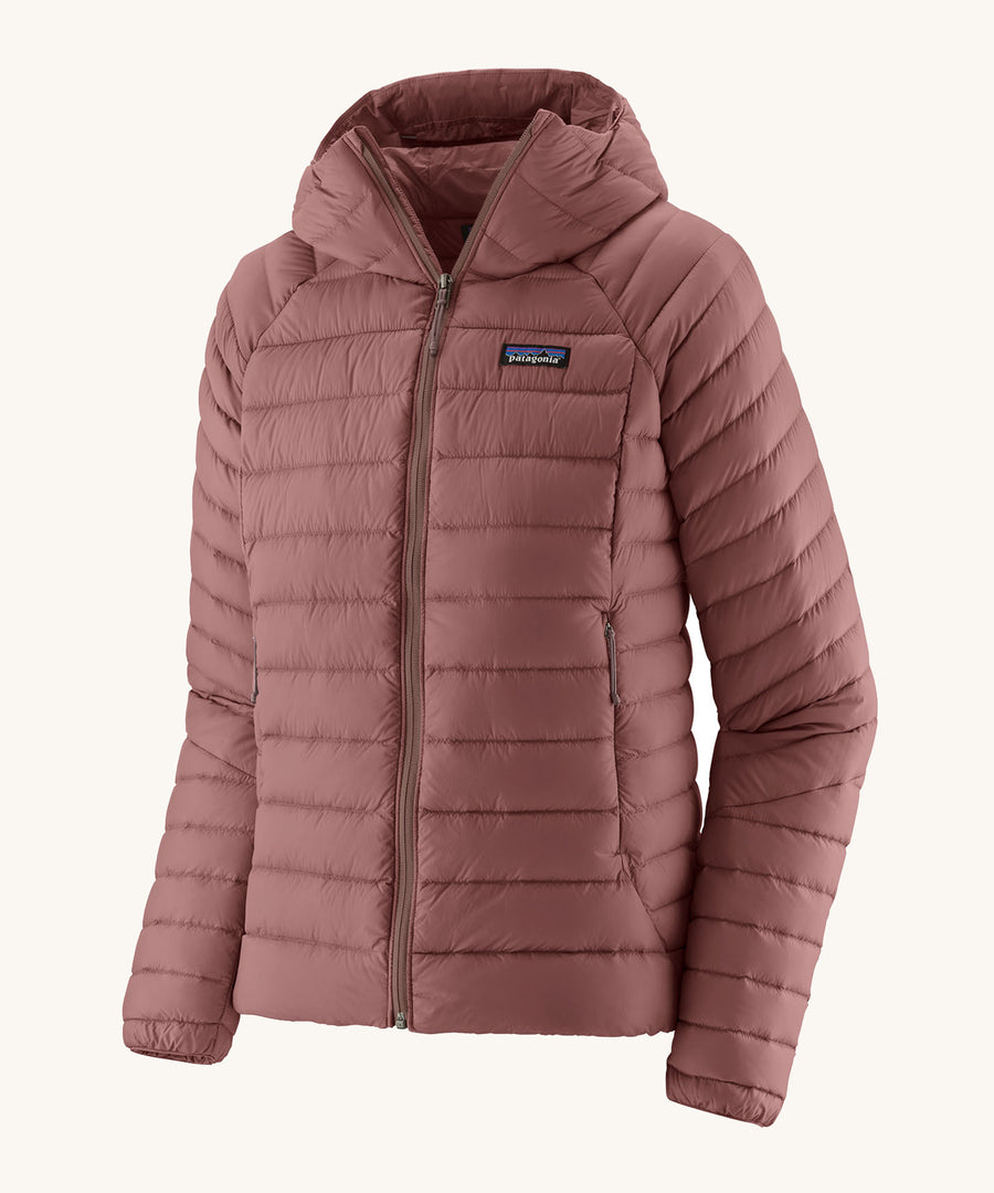 Patagonia Women's Down Sweater Hoody - Dulse Mauve. A light weight  coat in a light pink colour, on a cream background