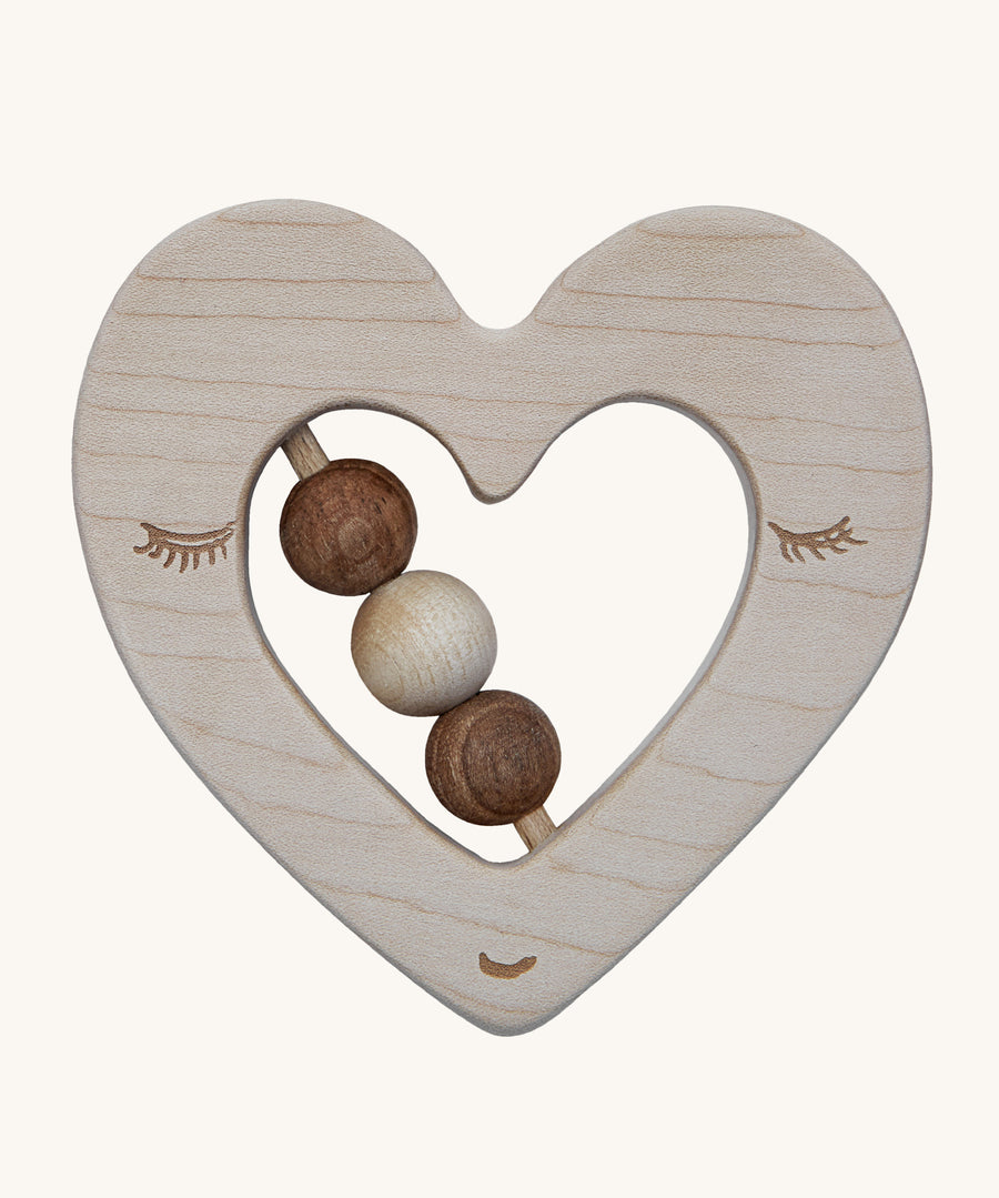 The Wooden Story Heart Rattle is a beautiful, sensory, wooden teething toy. The rattle is in a heart shaped design, with 3 wooden beads in the middle, and a face etched onto the front