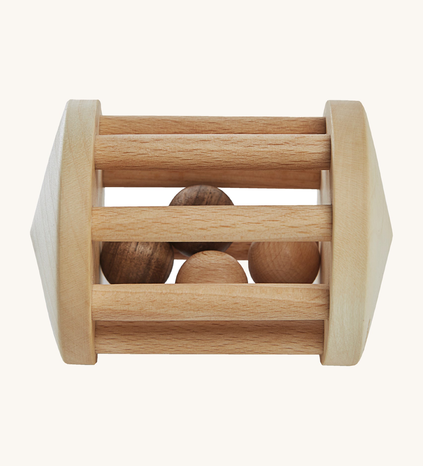 Wooden Story Turtle Dove Rattle, is a beautiful, wooden baby rattle toy. The wooden balls inside the rattle create a wonderful sensory experience for anyone playing with it. The image is on a cream background