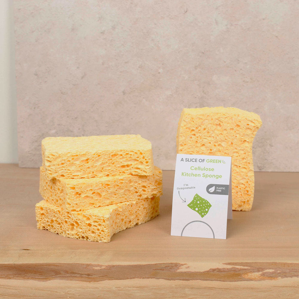 Stack of A Slice of Green cellulose kitchen sponges on a wooden work top