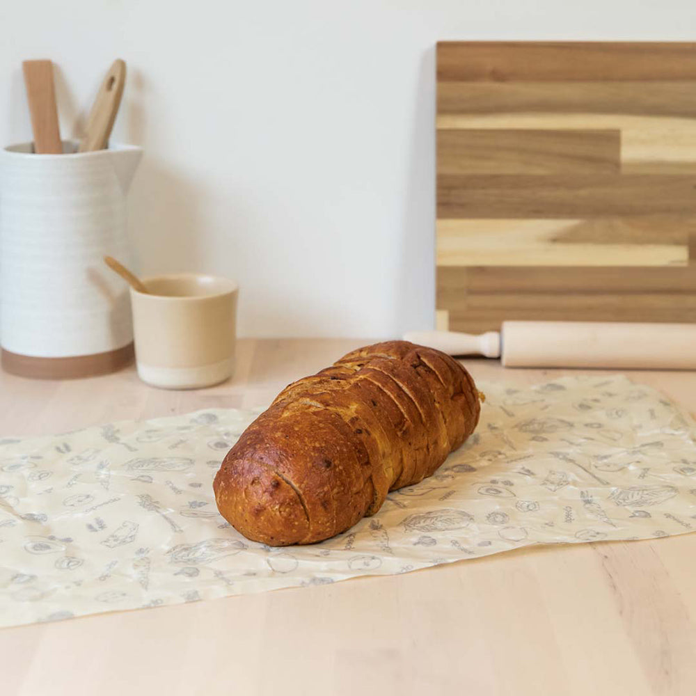 shaped into a bag and filled with leaves on a wooden worktop