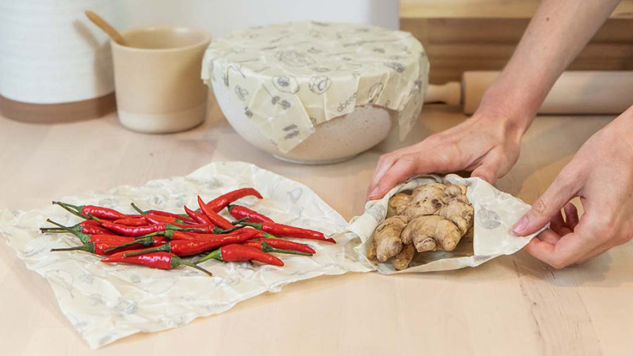 Person wrapping chillies and ginger in Abeego food wraps