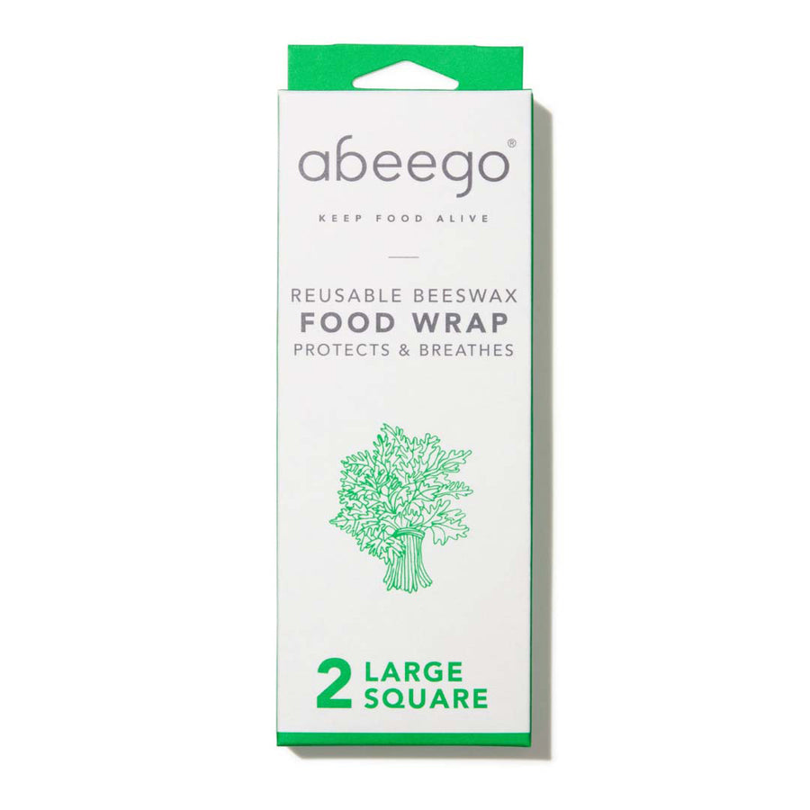 White cooking pot wrapped in the Abeego reusable beeswax food wraps on a kitchen counter