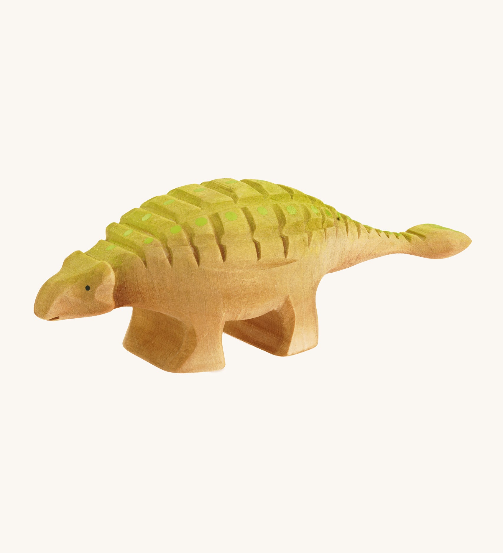 Big wooden Bumbu green and light brown Ankylosaurus on a cream background