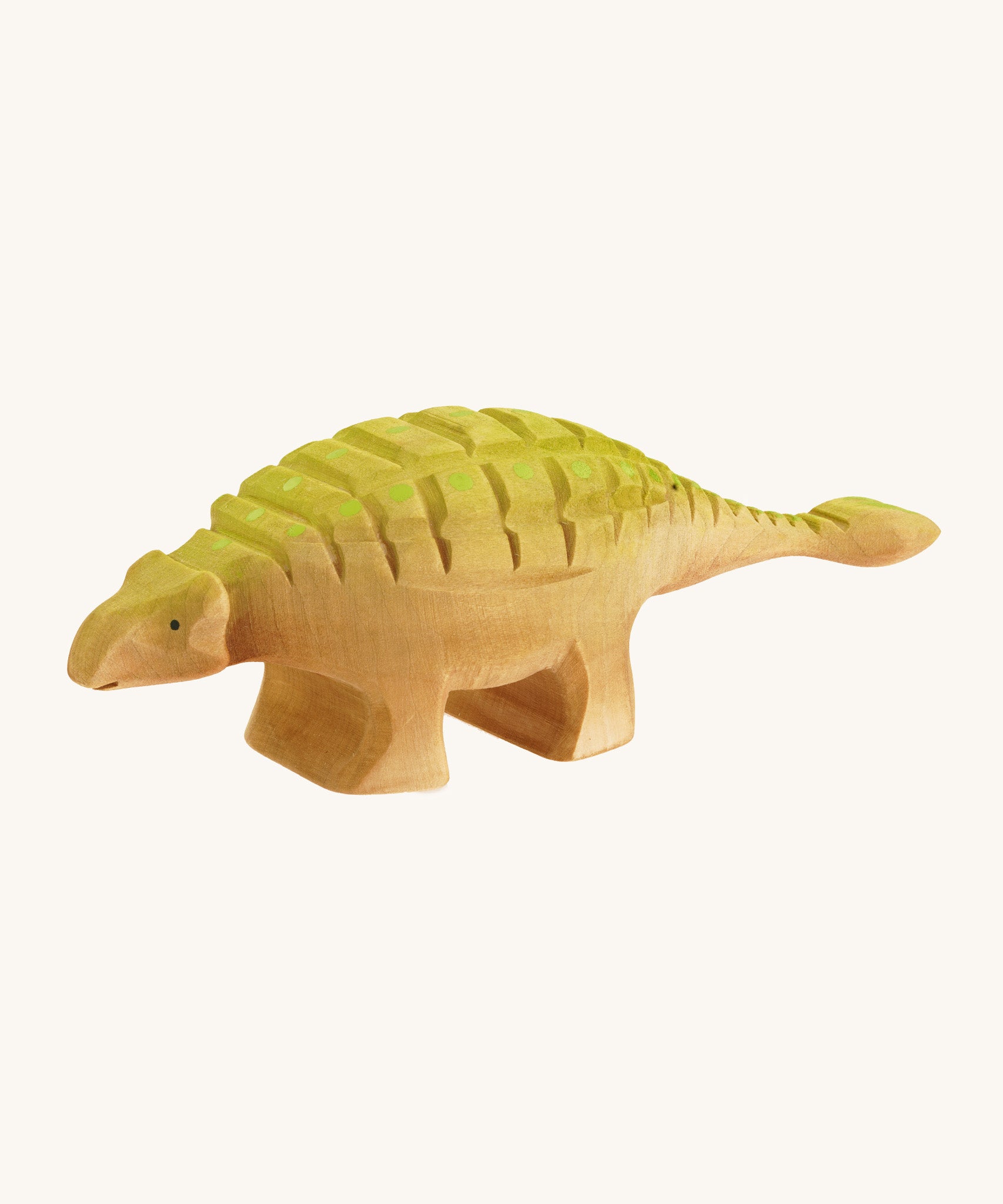 Big wooden Bumbu green and light brown Ankylosaurus on a cream background